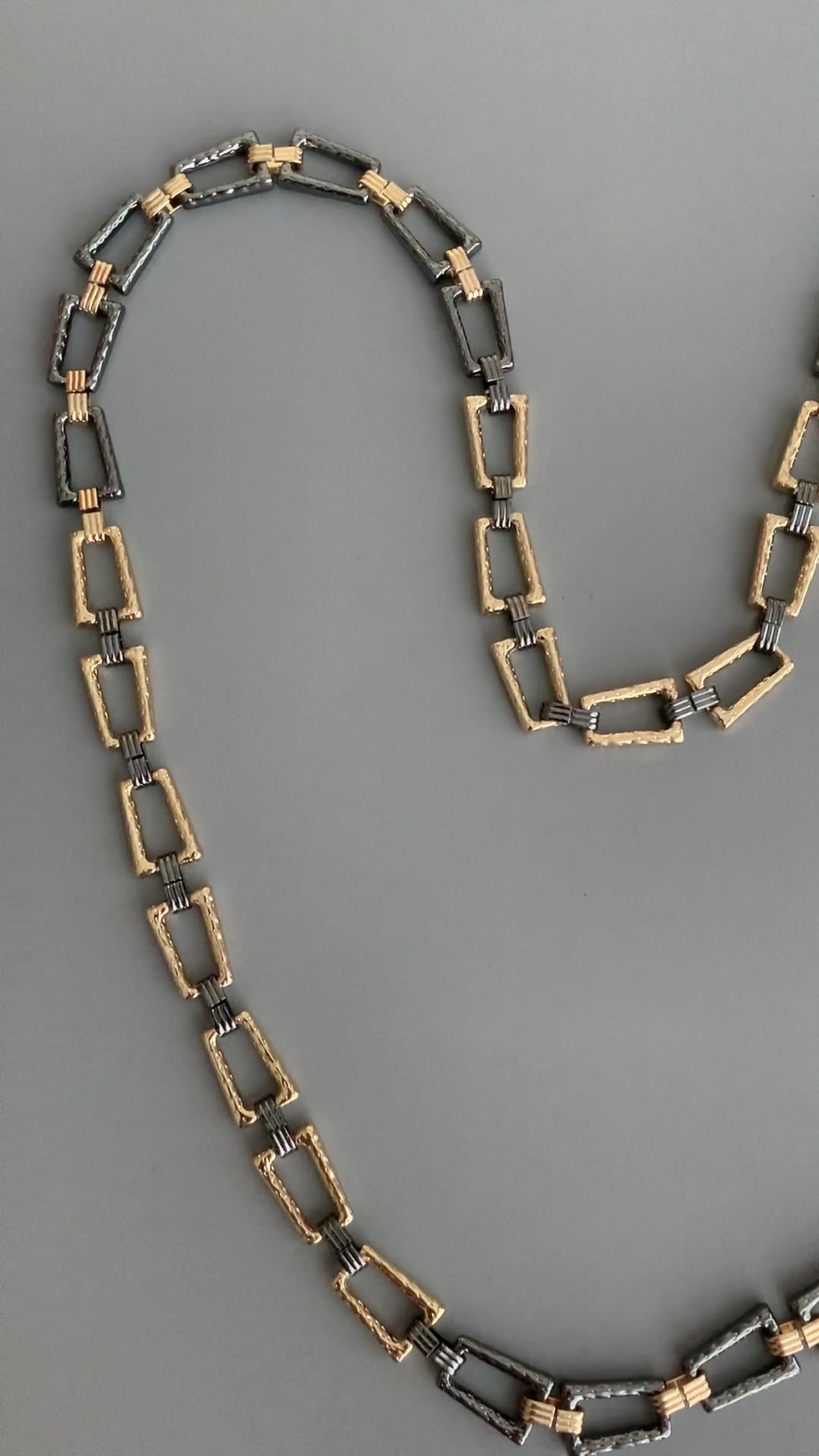 Thumbnail: A video of a long gunmetal and gold chain necklace