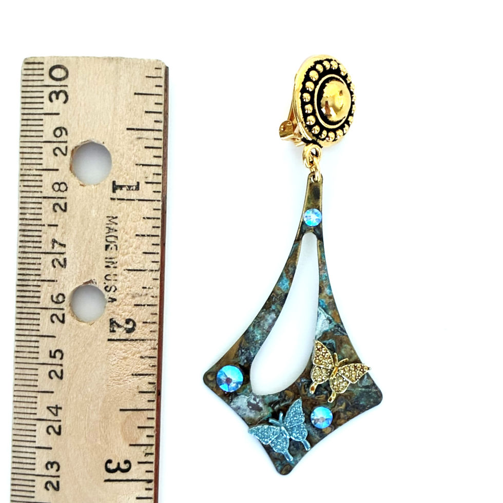 Thumbnail: Patina boho dangle clip on earrings next to a wooden ruler indicating the 3 inch length.