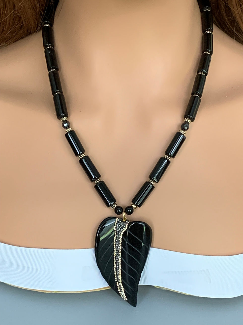 Thumbnail: Black beaded necklace with large leaf pendant