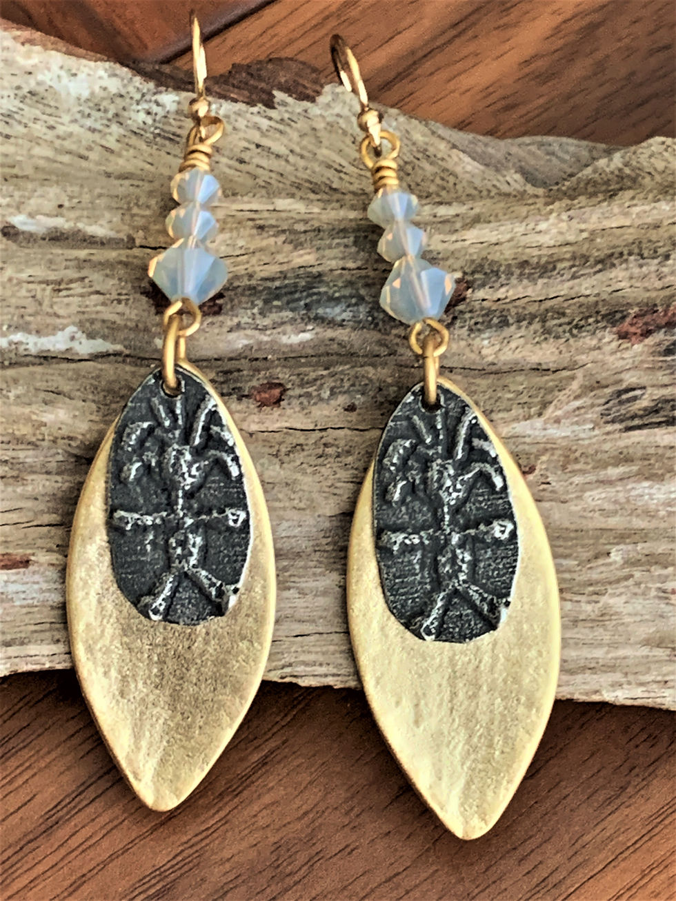 Thumbnail: Handcrafted dangle earrings with blue beads, tribal figures, and brass leaf