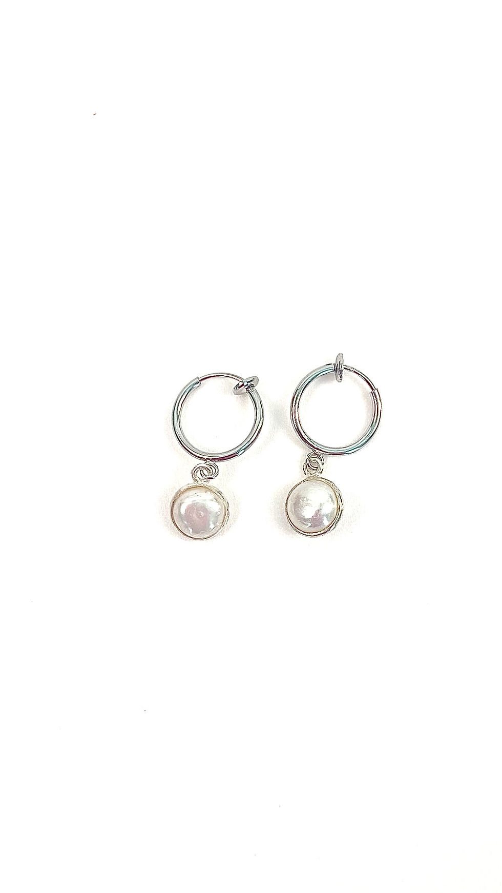 Thumbnail: A video of petite white pearl huggie clip on earrings in silver