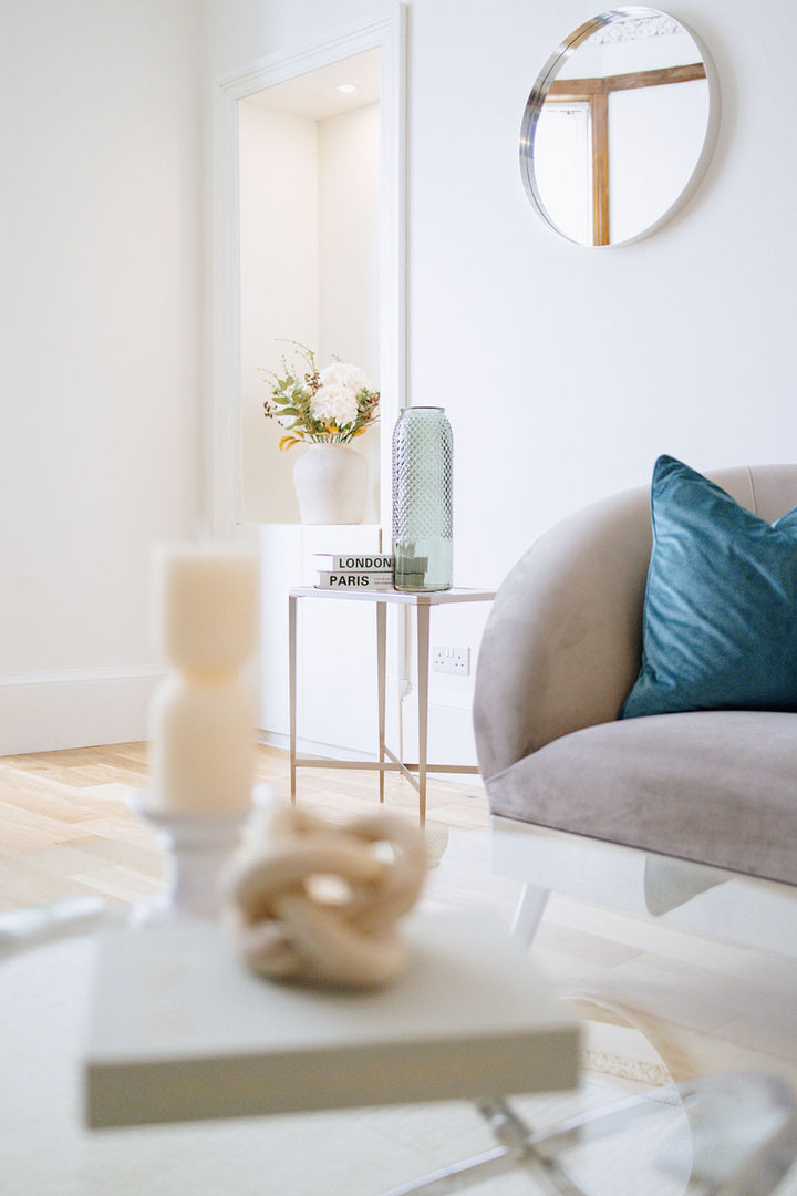 Luxury staged living room with neutral furniture and teal accents