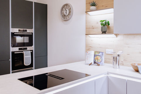 Fully staged luxury kitchen to compliment the teal green cabinets, modern design, and high-end styling detail.