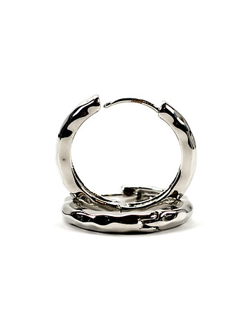 Pair of silver hoop earrings on white ba