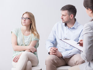 A woman looks away and the man is gazing at her.
