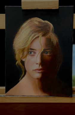 Oil study of a blonde woman lit dramatically against a dark background