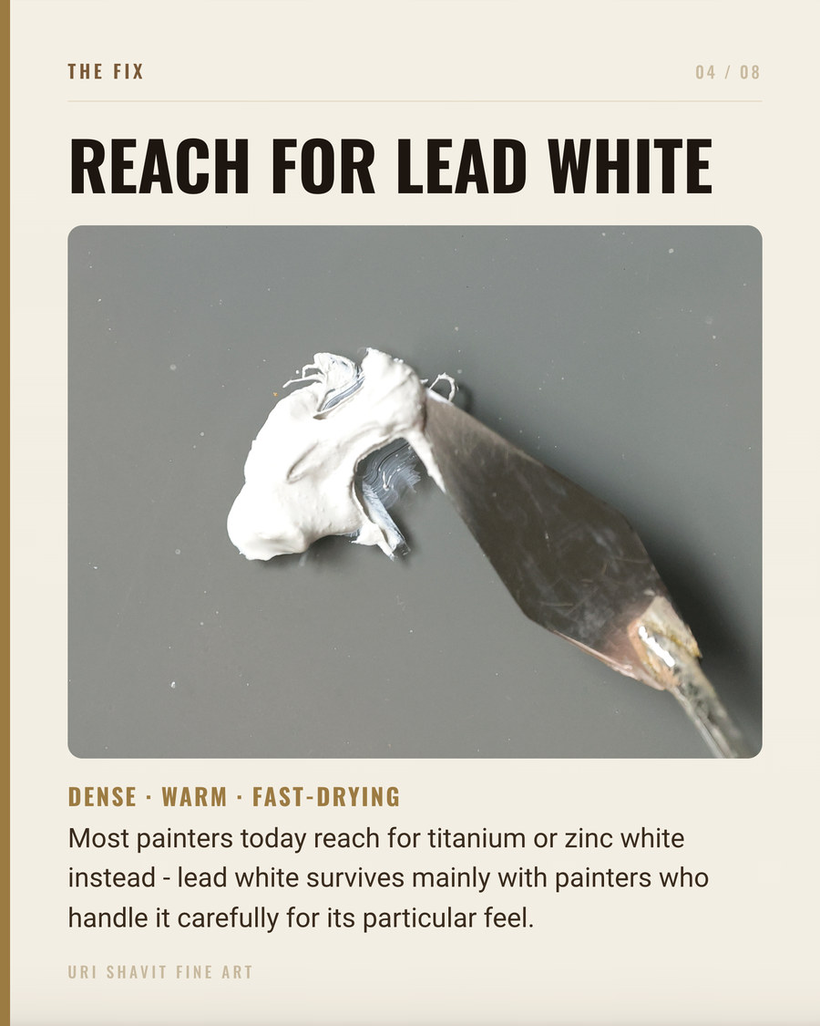 Lead white PW1 oil paint on a palette showing warm creamy tone and ropey texture