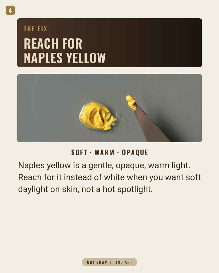Naples yellow PY41 oil paint on a white palette showing its warm opaque reddish-yellow color
