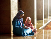 Mom Reading a Book to her Daughter