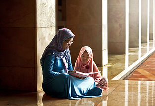 Mom Reading a Book to her Daughter