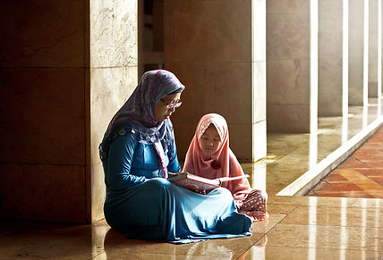 Mom Reading a Book to her Daughter
