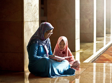 Mom Reading a Book to her Daughter
