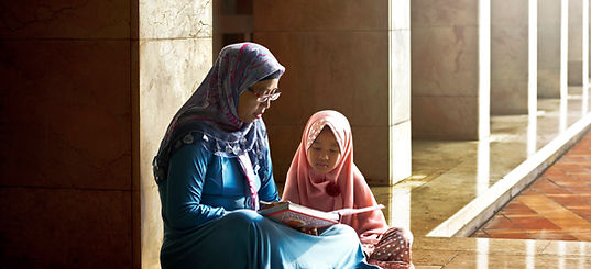 Mom Reading a Book to her Daughter