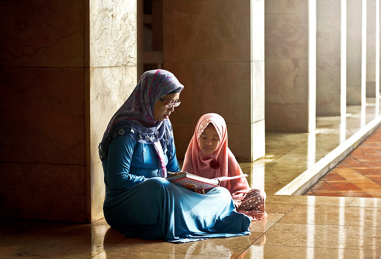 Mom Reading a Book to her Daughter