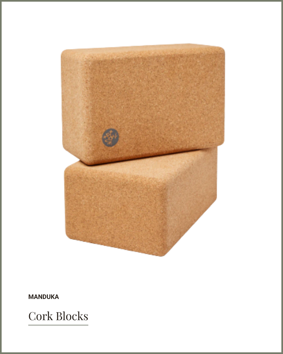 Two stacked cork yoga blocks with a Manduka logo against a plain white background. Text below reads "Manduka Cork Blocks."