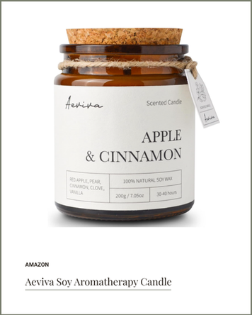 Soy aromatherapy candle in amber jar with apple and cinnamon scent, ideal for relaxation and cozy vibes.