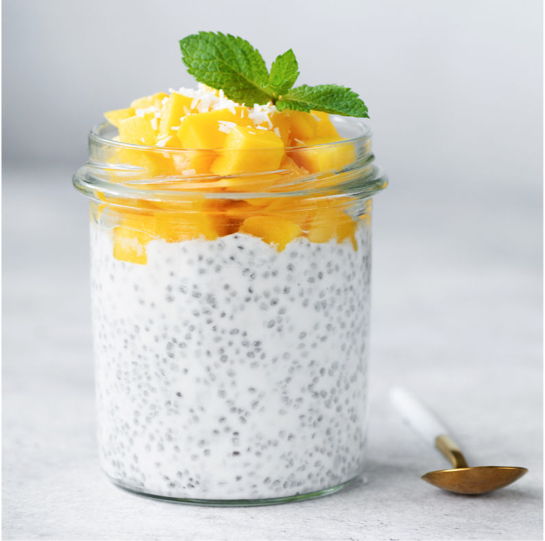 Chia pudding with fresh mango and mint in a glass jar