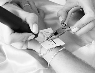 permanent jewelry being put on