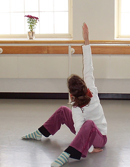 young woman in yoga sitting pose, raching upward