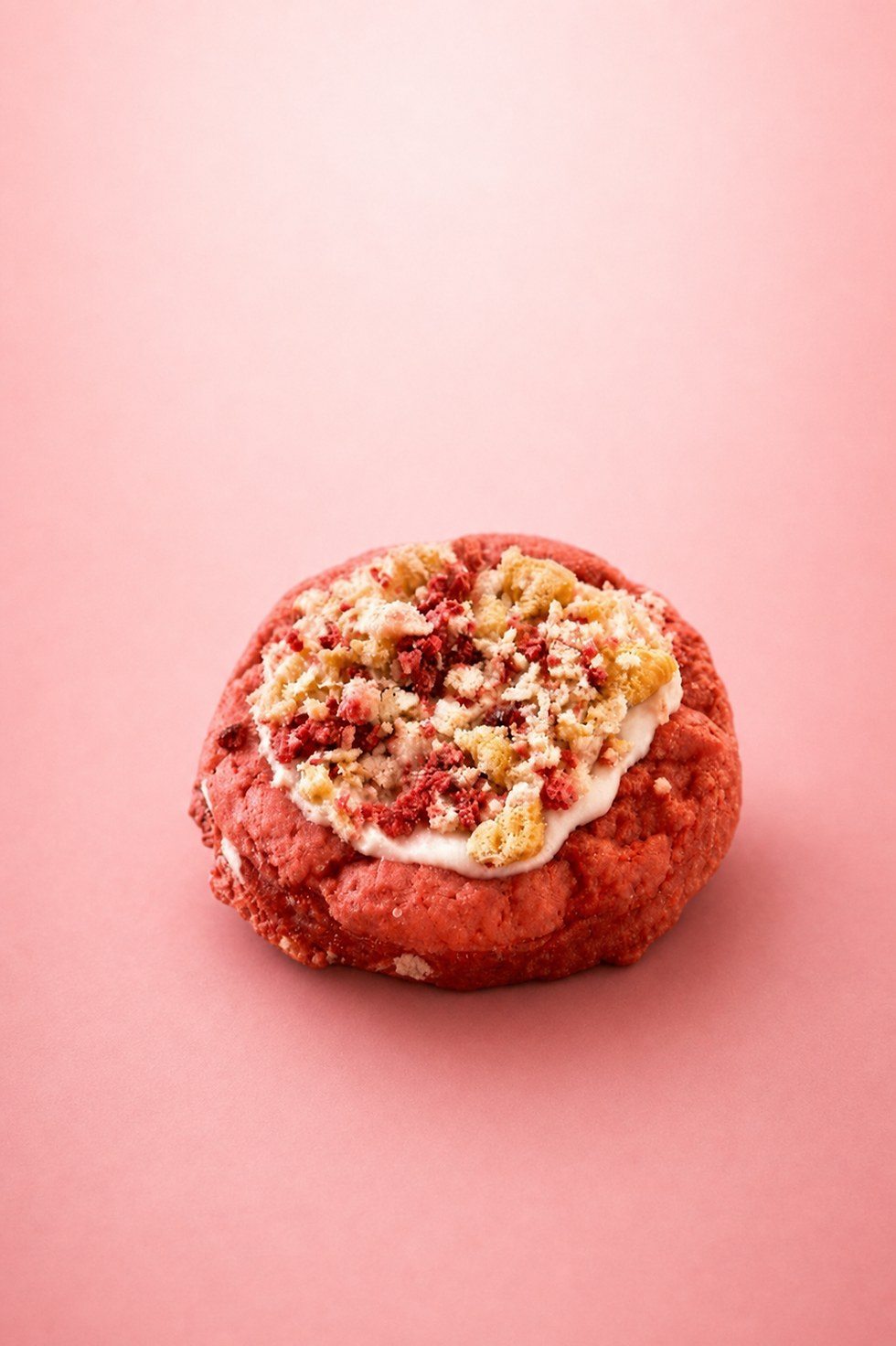 Strawberry Crunch Cookie topped with strawberry crumble and icing.