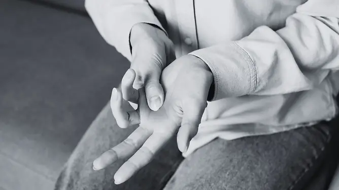 Person extending and stretching their fingers, illustrating limited range of motion associated with trigger finger