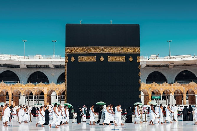 Men and women in traditional dress performing the tawaf at the Kaaba at al-Masjid al-Haram