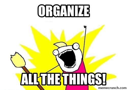 Cartoon character excitedly holding a broom with text "ORGANIZE ALL THE THINGS!" Bright yellow background with a pink shirt.