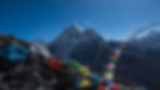 alt=“Snowcapped mountains in Nepal with prayer flags in the foreground, captured by Jimmy Hyland of JHP Visuals"