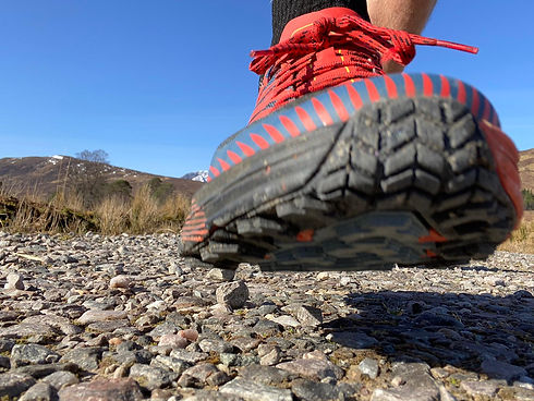 Trail running shoe on mountain path