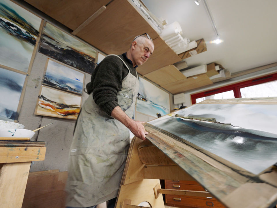 Stephen Redpath in artist studio painting a landscape