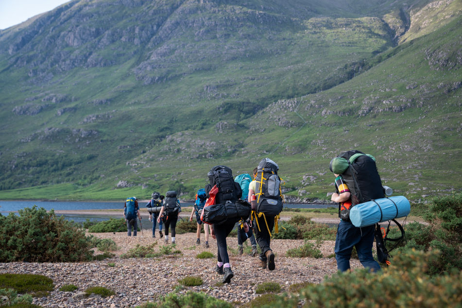 alt=“Gordonstouns pupils walking in the Scottish Highlands running captured during their expedition week by JHP Visuals"