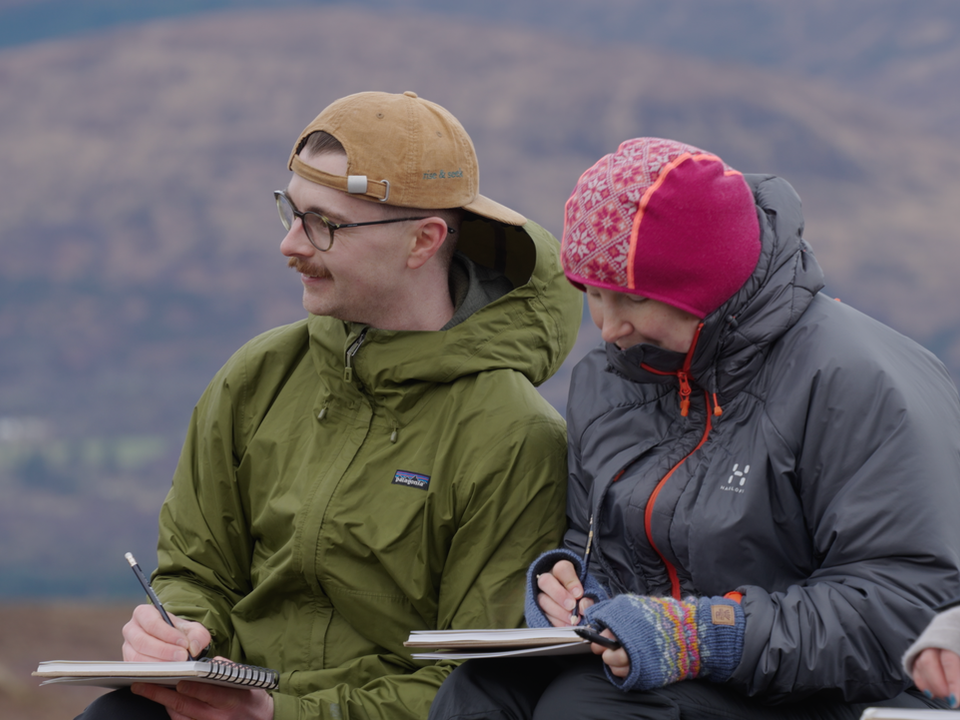 alt=Creative people sketching in the outdoors