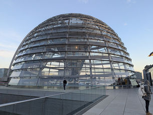 Visitors approaching the glass Reichstag dome in Berlin, one of the key free attractions tourists should reserve in advance