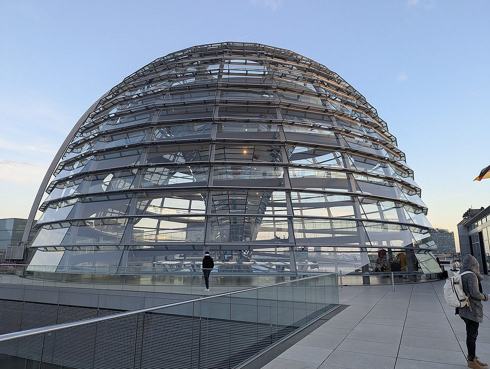 Visitors approaching the glass Reichstag dome in Berlin, one of the key free attractions tourists should reserve in advance