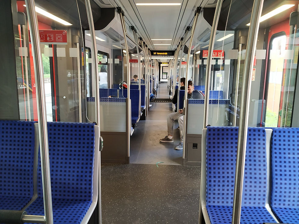 Interior of a modern Berlin S-Bahn with an overhead display reading S47 Hermannstrasse