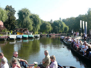 Punts full of visitors setting off across the harbor basin in Lübbenau