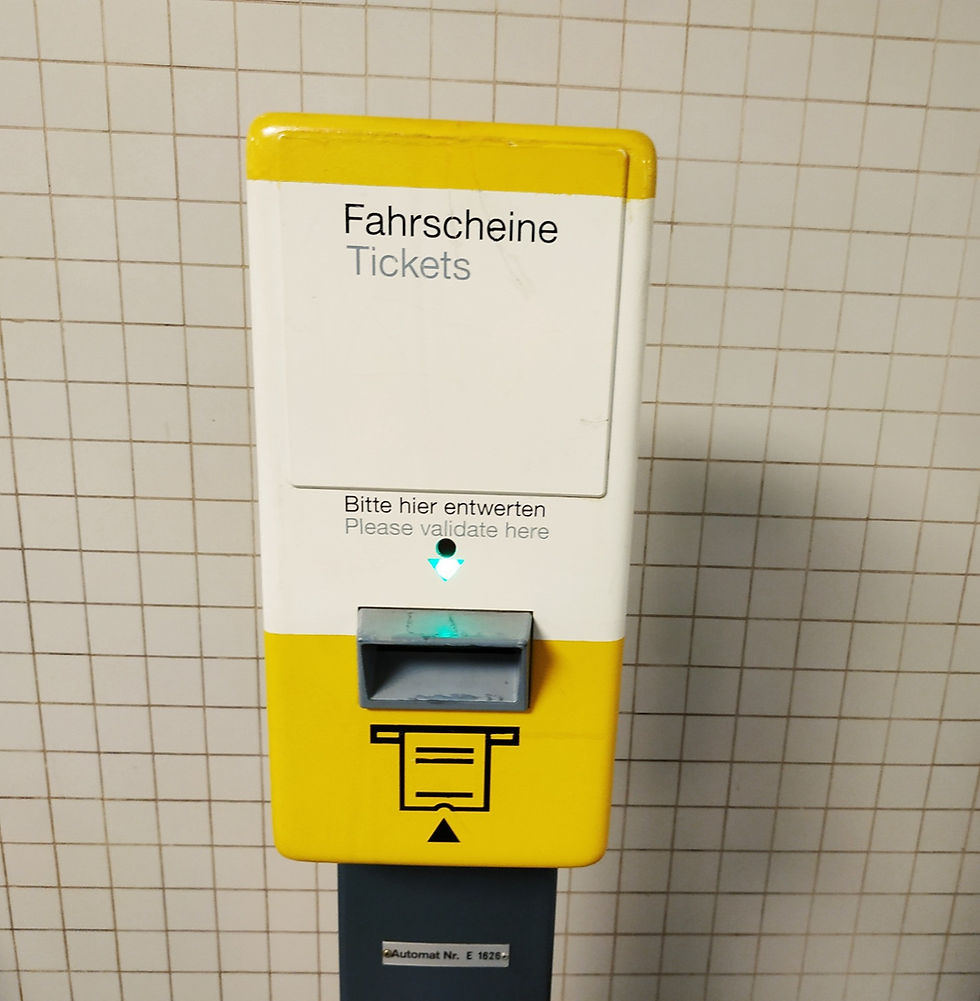 A yellow Berlin validation box labelled Bitte hier entwerten, Please validate here, with a slot for stamping tickets.