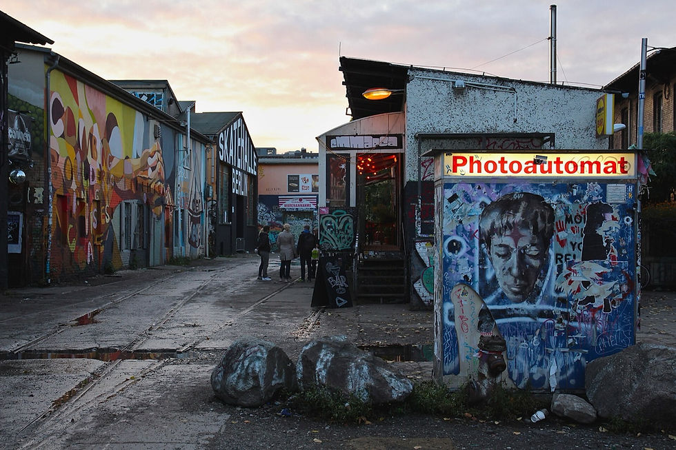 The RAW-Gelände in Friedrichshain at dusk, with street art, a Photoautomat booth and the Skatehalle