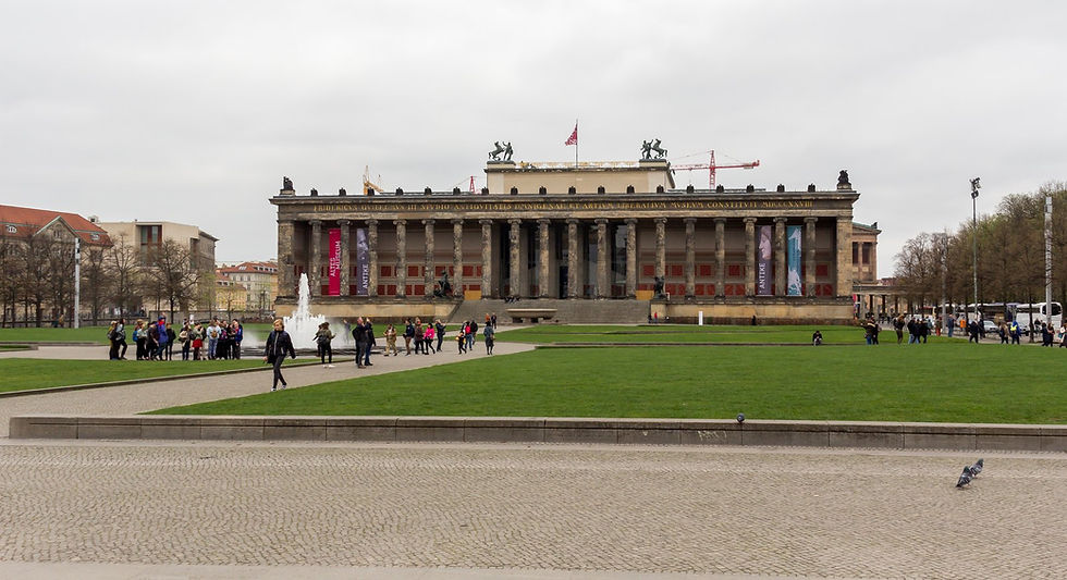 The Altes Museum and the Lustgarten lawn on Museum Island with visitors on a bright day
