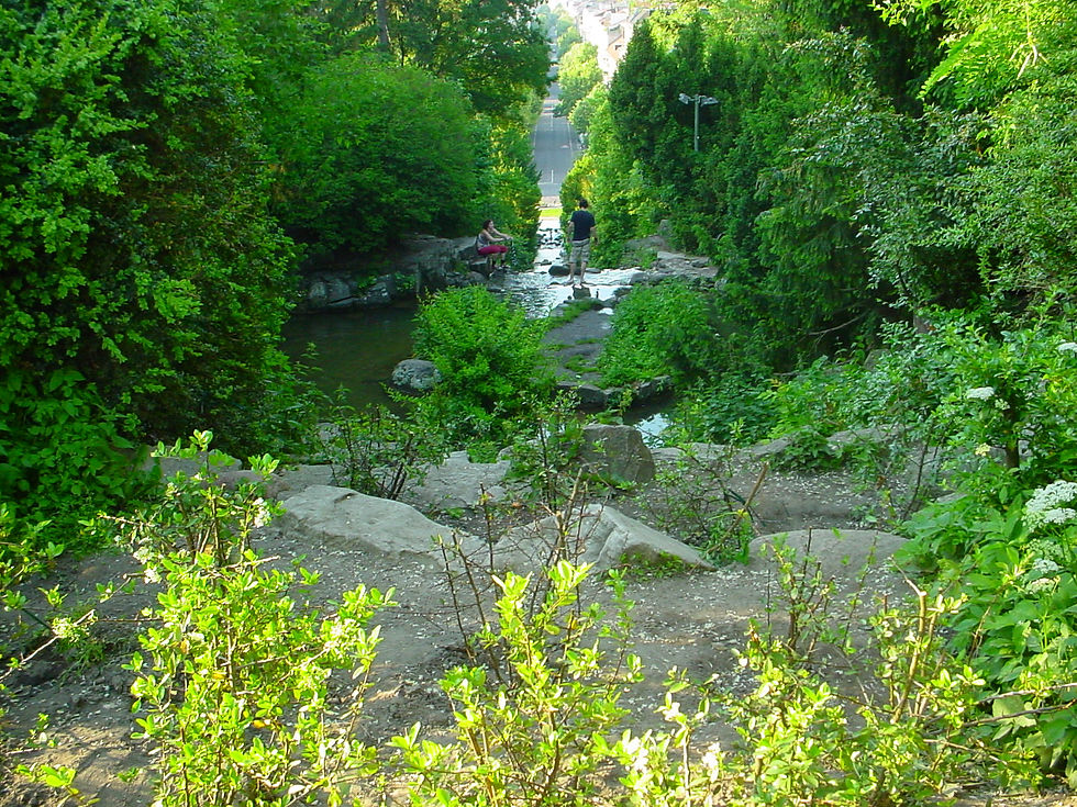 The artificial waterfall in Viktoriapark, flowing down the slope of the Kreuzberg hill in summer greenery