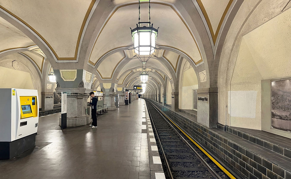The vaulted platform hall at Heidelberger Platz with hanging lamps and stone piers