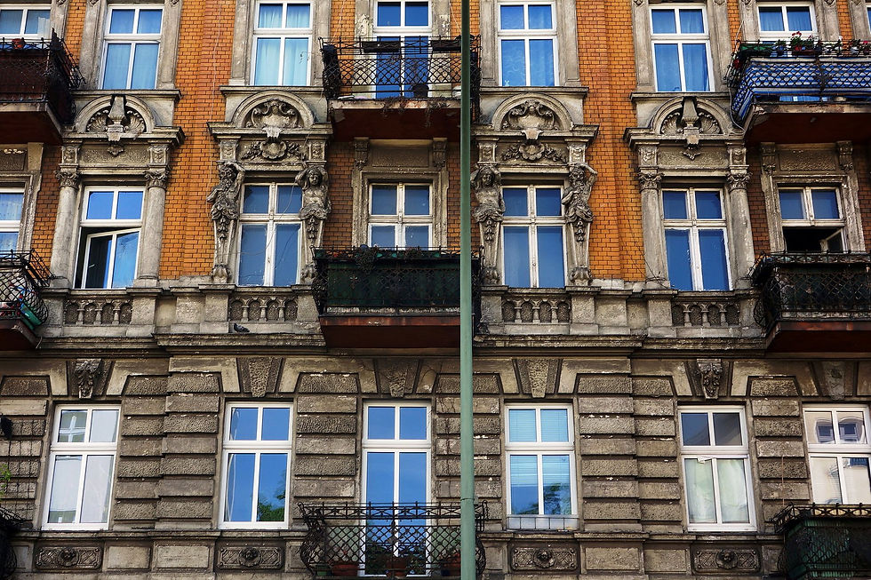 A Gründerzeit apartment building on Hermannstrasse in Neukölln, with red brick and stucco ornament above the ground floor windows