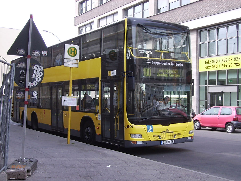 A yellow BVG double-decker bus on line 100 to Zoologischer Garten at the Alexanderplatz stop in Berlin