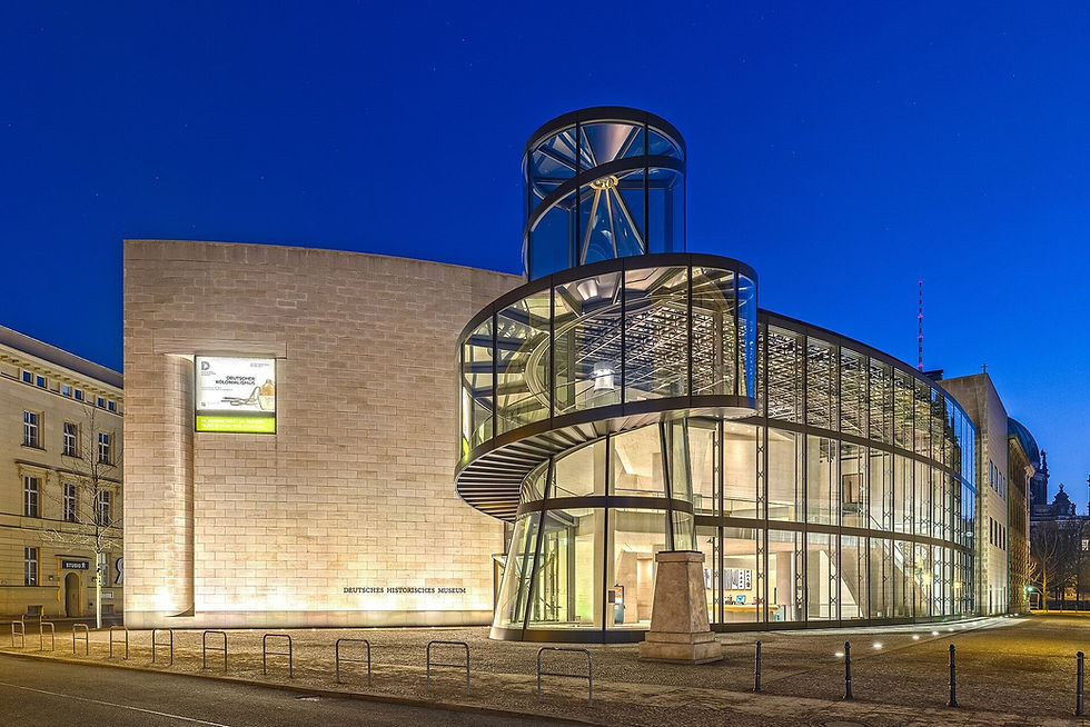 The glass spiral staircase of the Pei building at the Deutsches Historisches Museum lit up at night