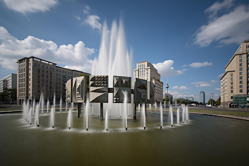 The Schwebender Ring fountain at Strausberger Platz with 1950s tower buildings and the TV Tower behind
