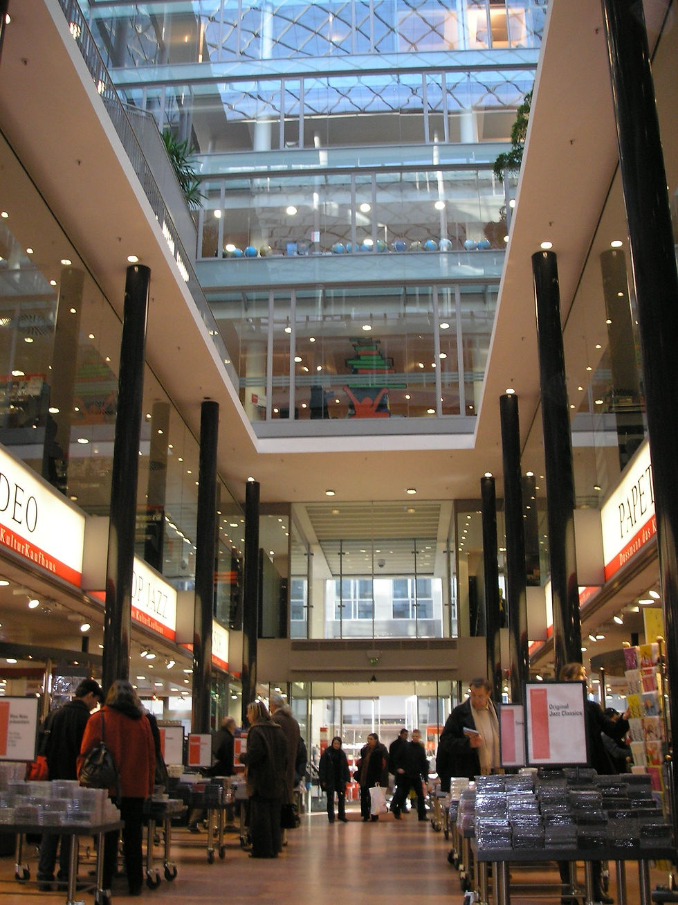A multi-level Dussmann interior with shelves and escalator lines