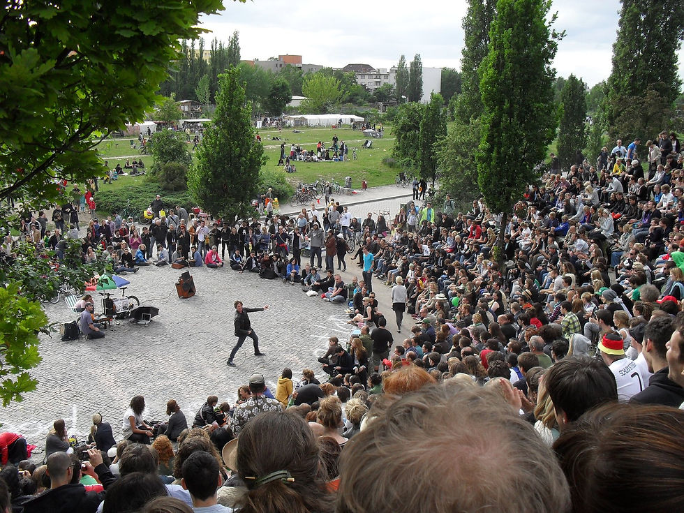 A large crowd filling the stone amphitheatre for Bearpit Karaoke at Mauerpark on a Sunday afternoon
