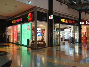 Alexa Apotheke pharmacy in Berlin with illuminated red and green signage
