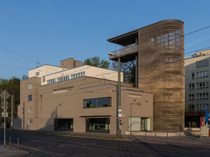 Preserved section of the Berlin Wall border strip with the documentation centre viewing tower on Bernauer Strasse.