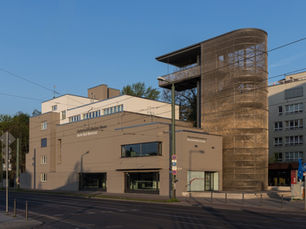 Preserved section of the Berlin Wall border strip with the documentation centre viewing tower on Bernauer Strasse.